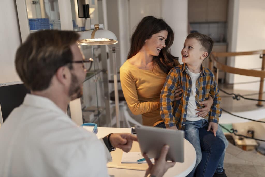 Mother with her son in eye care doctor clinic