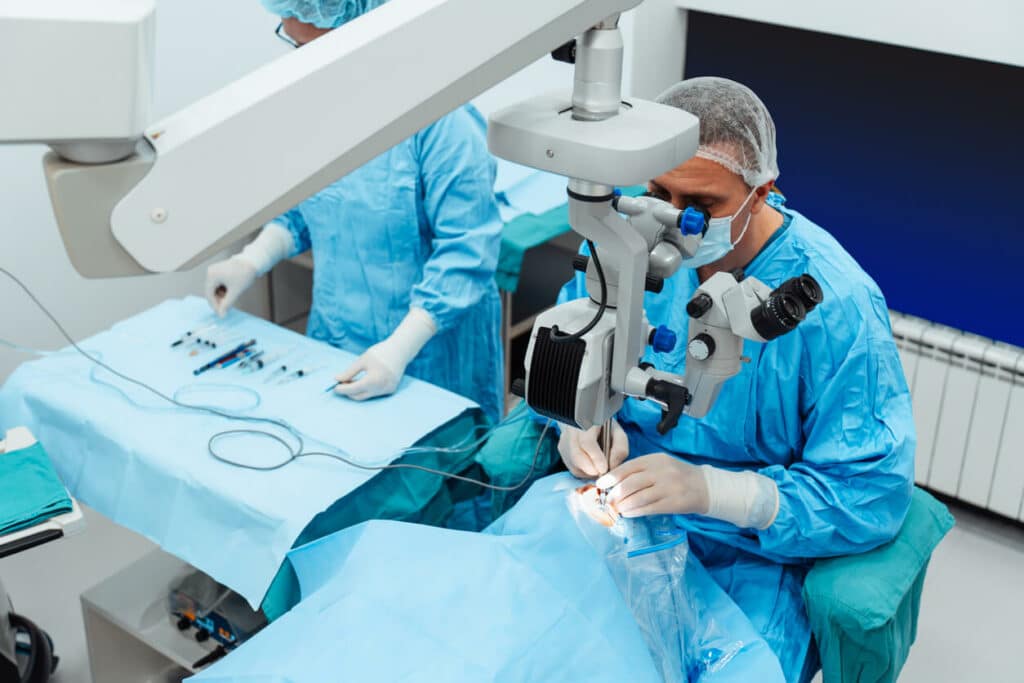 A cataract surgeon performing eye surgery on a cataract patient at an eye clinic.