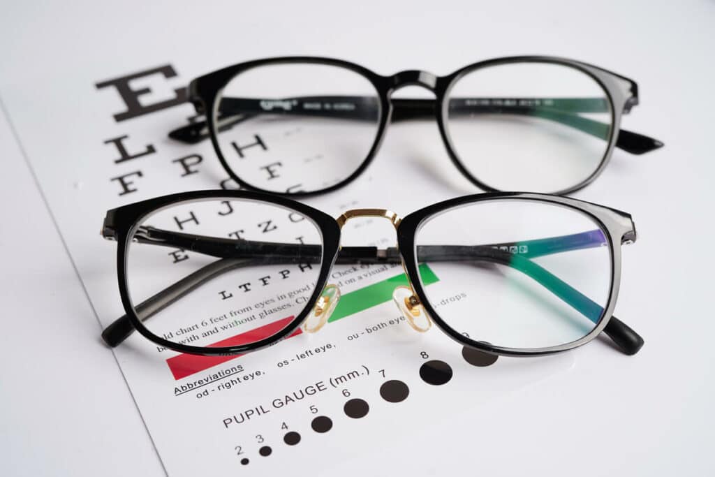 Glasses on an eye exam chart test patients' eyesight accuracy for same-day prescription glasses.