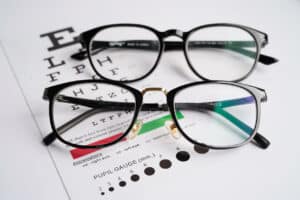 Glasses on an eye exam chart test patients' eyesight accuracy for same-day prescription glasses.