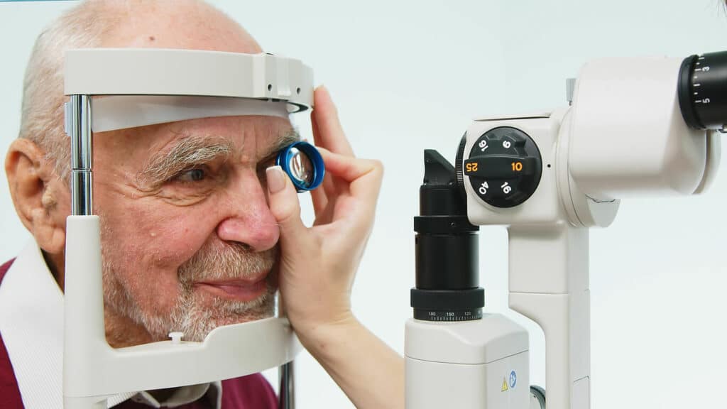 An ophthalmologist checks the vision of an elderly person during glaucoma testing, using modern equipment.