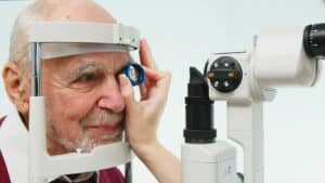 An ophthalmologist checks the vision of an elderly person during glaucoma testing, using modern equipment.