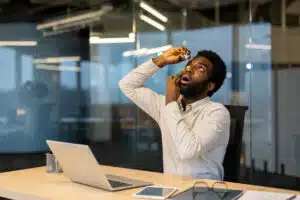 A man drips medicine drops into his dry eyes.